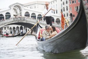 Italy, Venice, couple riding gondola, kissing