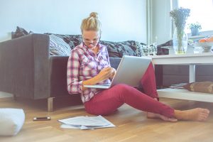 Young woman at home working on a laptop computer