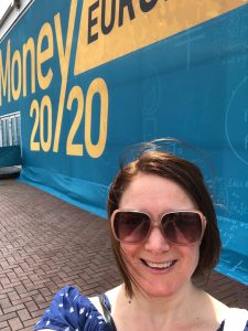 Megan posing in front of Money 20/20 sign