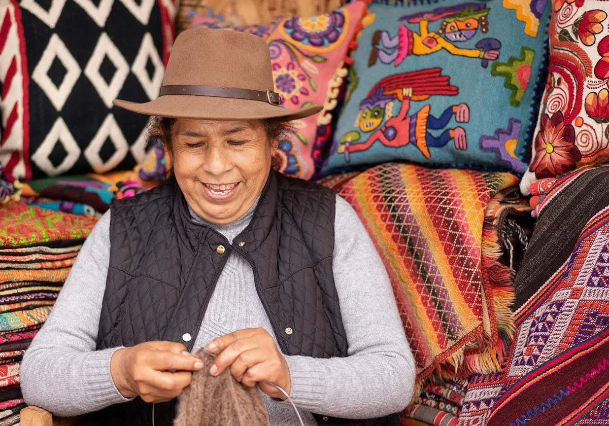 Woman knitting and smiling