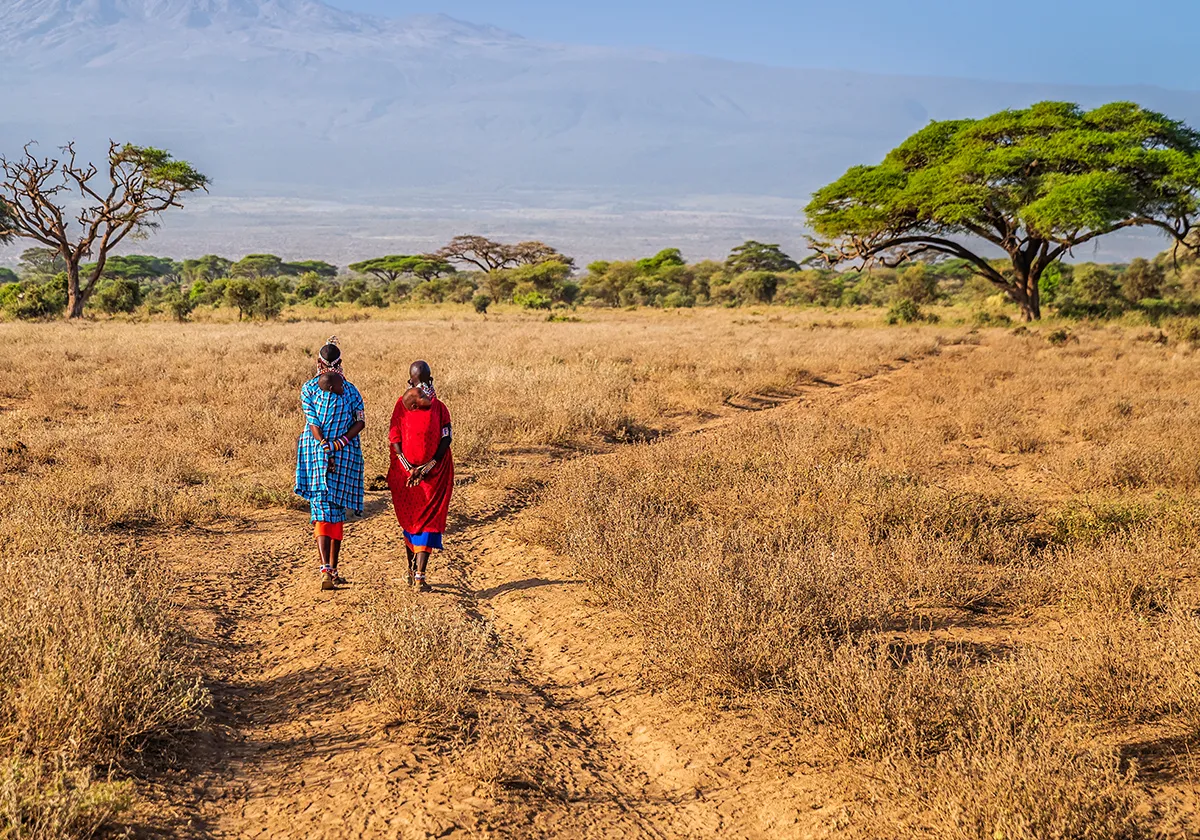 African woman walking down the desert