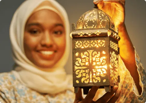Woman holding a lantern for Ramadan event
