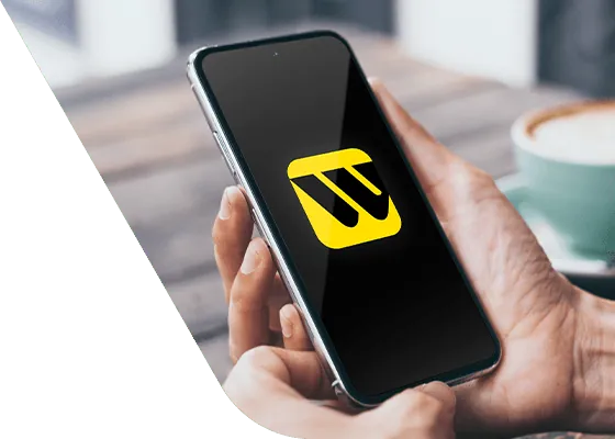 Person holding an iPhone using the Western Union app to send money to Canada