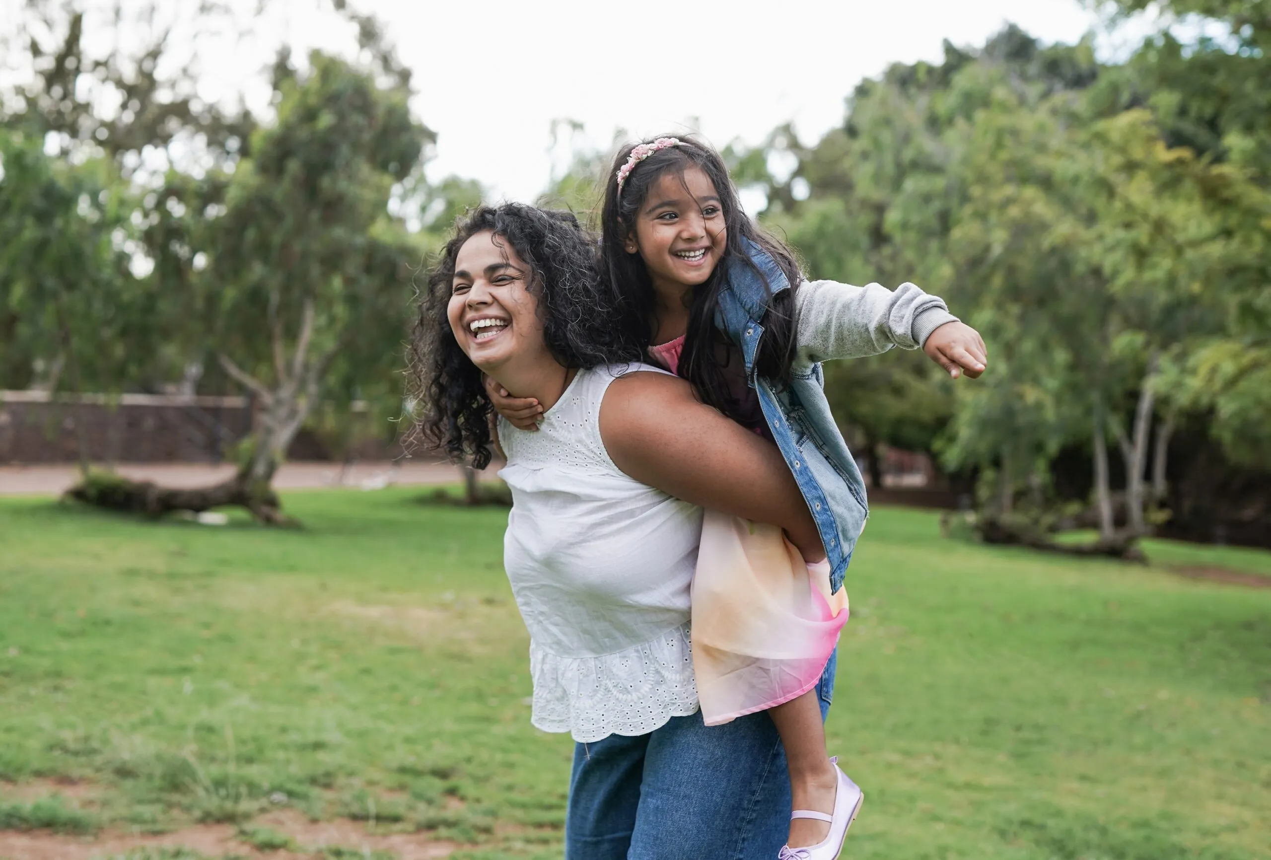 Mom giving daughter a piggy back ride, send money from Japan to India