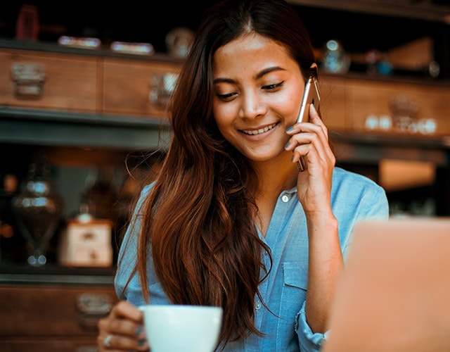 Smiling woman holding mobile
