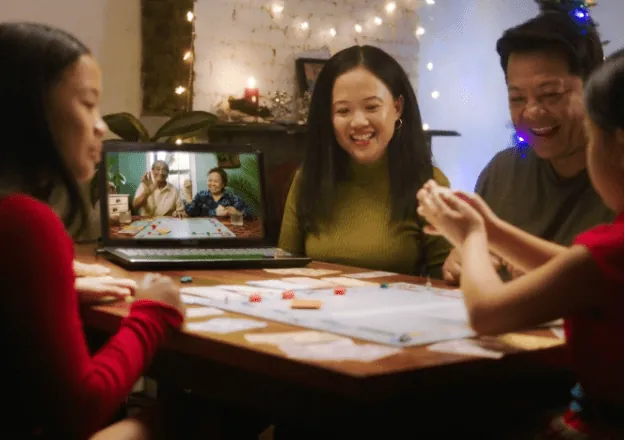 Family sitting at the table playing board games
